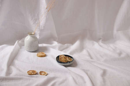 Dried lemon slices on a white delicate background showing the concept and feeling of Spring and...