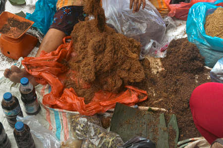 High angle view of a market vendor selling dried tobacco fibers in Bukit Lawang North Sumatra, Indonesiaの写真素材