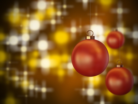 3 red christmas spheres hanging on a lit backgroundの写真素材