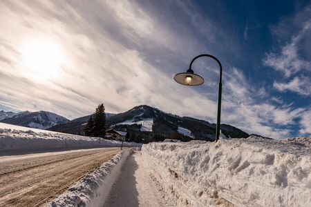 Empty road in winter Rohrmoos-Untertal, Schladming, Schladming-Dachstein, Dachstein massif, Liezen District, Styria, Austria, Europeの写真素材