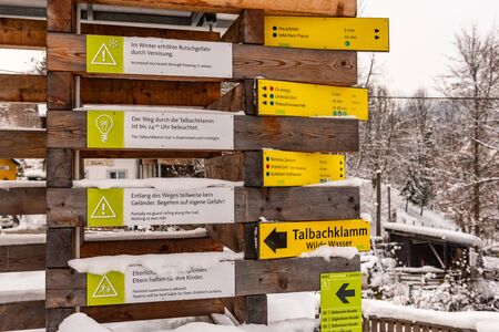 Yellow Tourist Directional Signs. Information to visitors about paths, attractions, distances and points of interest. Schladming Dachstein, Styria, Austria, Europeの写真素材