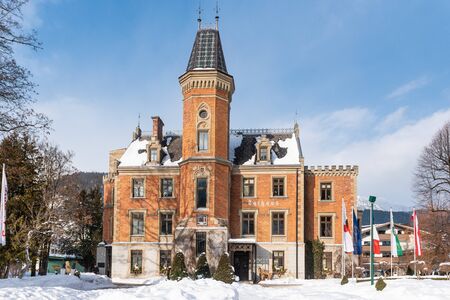 Schladming Town Hall in winter, snow covered park, in the centre of the city. It is housed in the former hunting lodge of Prince Augustus of Saxe-Coburg and Gotha.のeditorial素材