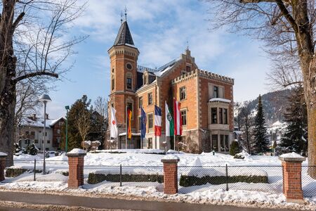 Schladming Town Hall in winter, snow covered park, in the centre of the city. It is housed in the former hunting lodge of Prince Augustus of Saxe-Coburg and Gotha.のeditorial素材