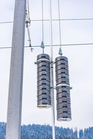Railway electrification system details- electric power overhead line, steel pylon close up against...