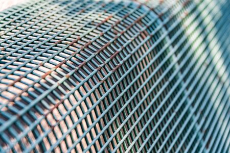 Close-up of a bench made of metal rods. Abstract background with selective focus. Clear lines and...