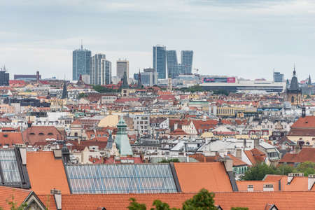 Above view at the cityscape of Prague on a sunny day. The detail view of modern and old part of town with traditional red rooftops.のeditorial素材