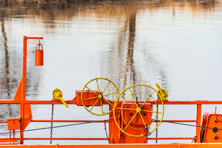The details of the cable ferry which across a river by cables connected to both shore. The orange...