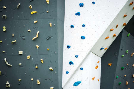 Abstract colorful of rock climbing wall with toe and hand hold studs., Various colored grips at...
