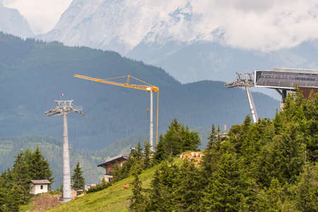Construction of a new ski lift. Support pole, no steel ropes, standing alone on the slope. Upper ski...
