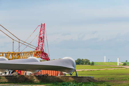 Construction site prepared for the assembly of a wind farm. Visible car crane, yellow crane and a...