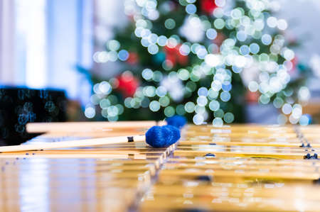 Vibraphone sticks lying on this percussion instrument. In the background, blurry, out-of-focus lights of the Christmas tree.の写真素材