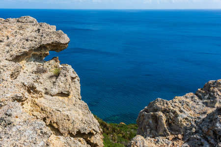 Weathering and erosion slowly gouge, grind and polish the rocks and then wash the debris off into the sea. Ponza is a mountainous island of volcanic origin, with steep, rocky shores and cliffs. Tyrrhenian Sea.の写真素材