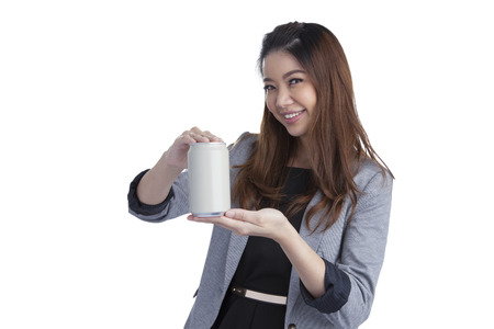 Young brunette businesswoman presenting a can of soft drink isolated on white background の写真素材