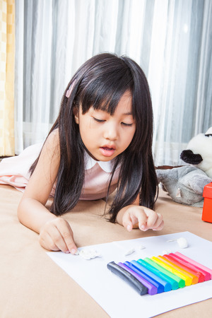 Little girl creating toys from playdoughの写真素材