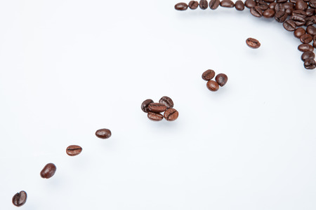 Heap of coffee beans and count coffee beans. isolated on white background.の写真素材