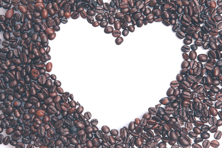 Heap of coffee beans with white heart. / love in coffee heart blank, isolated on white background.の写真素材