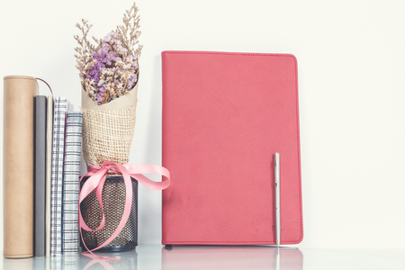 Empty notebook a pen, notebook and vintage flower white background, writing concept, normal view.の写真素材