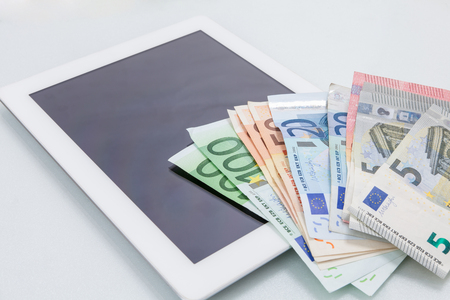 Financial concept. Make money on the Internet.  Digital tablet on white backgroundの写真素材
