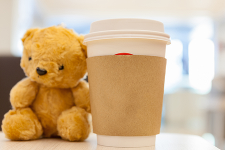 Coffee cup, blurred on teddy bear face in Blurred background with vintage filterの写真素材