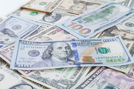 Multiple scattered American 100 dollar banknotes in full frame coverage with corner vignetting...