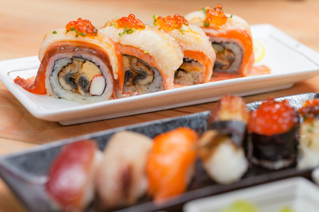 Maki. Closeup maki set at white plate on wooden table. japanese food concept.の写真素材