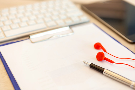 Office table top view with notepad, tablet, computer and pen. View from above with copy spaceの写真素材
