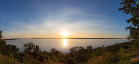 Panonamic sunset reflection in a lake at Ubonrat dam, Khon Khan city, Thailand.の写真素材