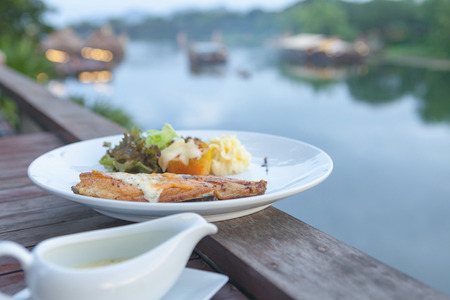 White sea bass steak sauce with river view.