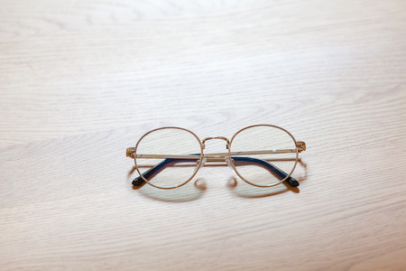 Optical vintage classic glasses isolated on wooden.