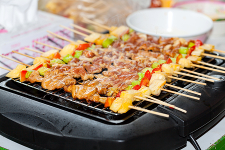 Barbecue grill with various kinds of meat, close-up at Thailand.の写真素材