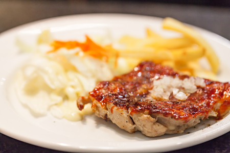 Grilled chicken breasts and vegetables on the plate glass.の写真素材