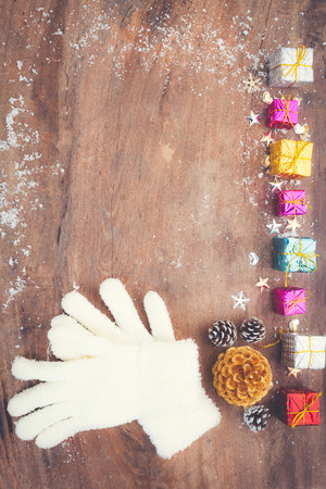 Mitten with christmas decoration on wooden board. Winter decorationの写真素材