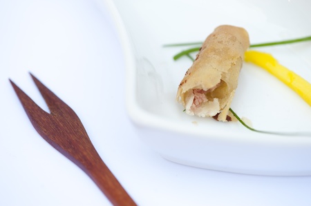 One bitten egg roll with a knifeの写真素材