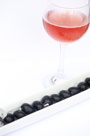 Black olives with a glass of rose wineの写真素材