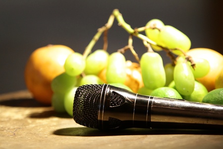 Microphone in front of fruitsの写真素材