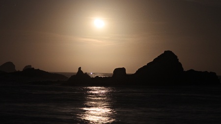 Moon above the reef on oceanの写真素材