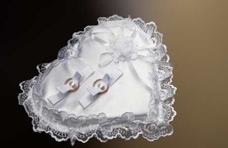 wedding rings on white heartの写真素材
