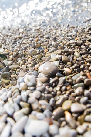 wet pebbles close-up background in waterの写真素材