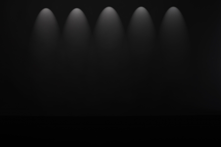 Spotlight studio interior, black background with lightsの写真素材