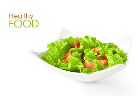 Healthy food background. Vegetable salad with tomatoes in plateの写真素材