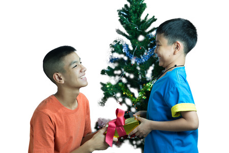 Happy Asian kid give present to his brotherの写真素材