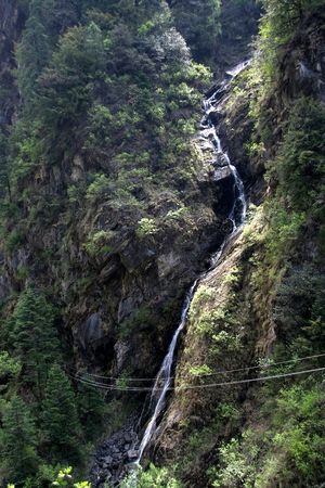 River falls through a great height along s-shaped rocky