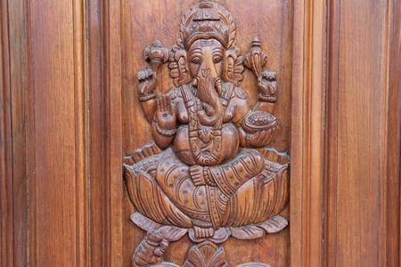 Bas relief etching of Ganesha on teakwood door panelの写真素材