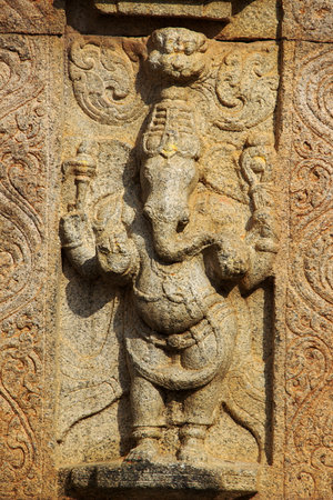 Sculpture of standing Ganesha on stone wall at Narasimha Temple in Nandi Hills near Bengaluru, Karnataka, India, Asiaのeditorial素材