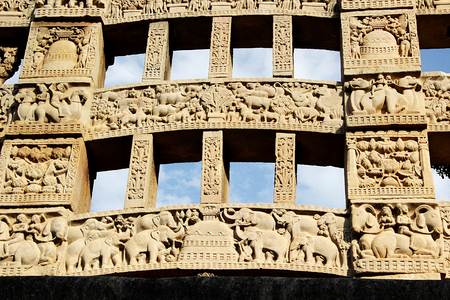 Close-up of exquisite carving on rear face of eastern gateway to great stupa at Sanchi, near Bhopal, Madhya Pradesh, India, Asiaの写真素材