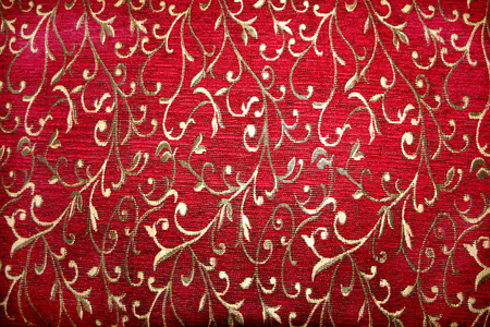 Red bed spread fabric laced with silver thread floral design