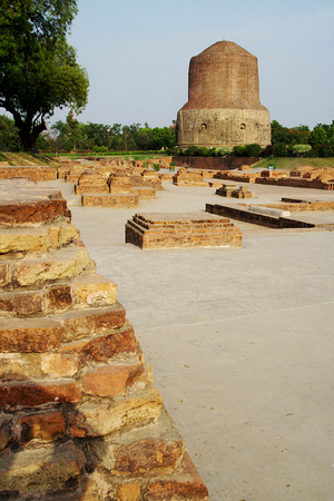 Dhamekh Stupa viewed along with traces of Buddhist structures  in foreground at Saranath near Varanasi in Uttara Pradesh, India, Asiaの写真素材