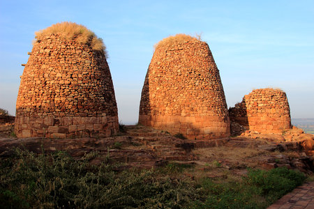 Three watch towers in evening sunlight against blue sky on top of northern hill at Badami, Karnataka, India, Asiaのeditorial素材