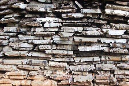 Frontal view of pile of weather-torn wooden planksの写真素材