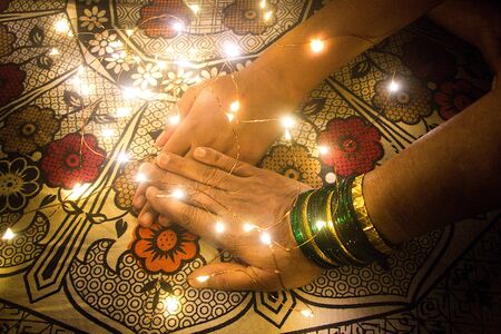 Playful action of tapping the LED light placed on bedsheetの写真素材